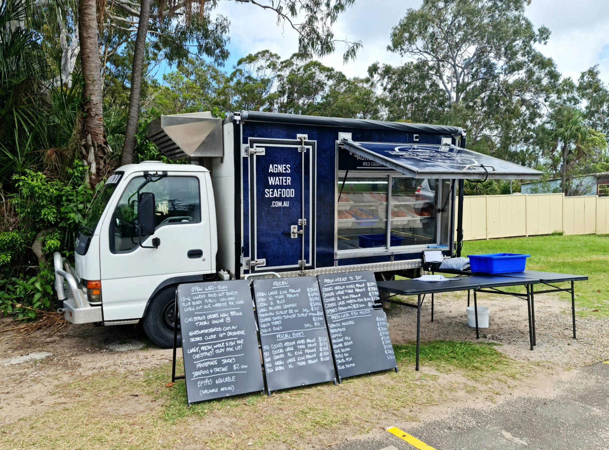 Agnes Water Seafood retail truck with tables and signs
